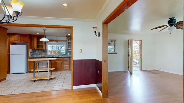 a kitchen with stainless steel appliances granite countertop a stove a sink and a refrigerator