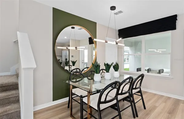a view of a dining room with furniture and wooden floor