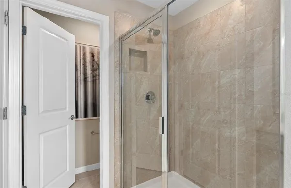 a bathroom with a glass shower door