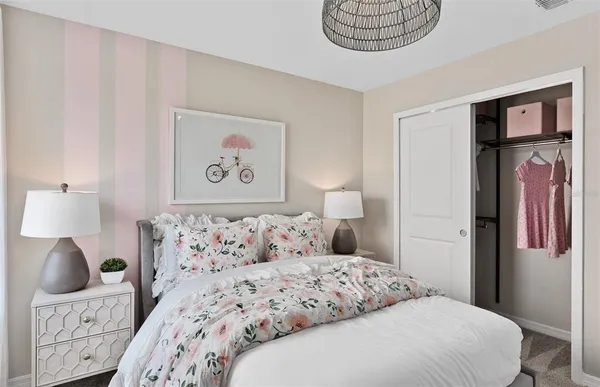 a bedroom with a bed and a painting on the wall