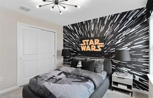 a bedroom with a bed and a ceiling fan