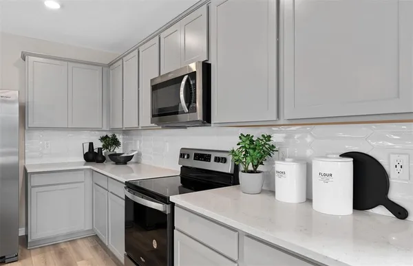 a kitchen with a sink and white cabinets