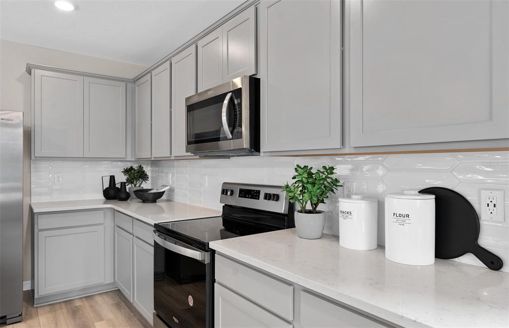 5013 Furrowed Way St. Cloud, FL 34771 - Photo 7 of 26 a kitchen with a sink and white cabinets