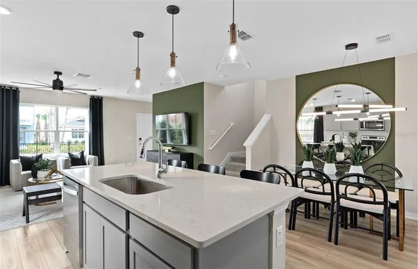 a kitchen with a table chairs sink and cabinets