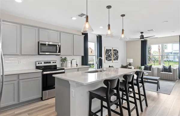 a large kitchen with a table and chairs