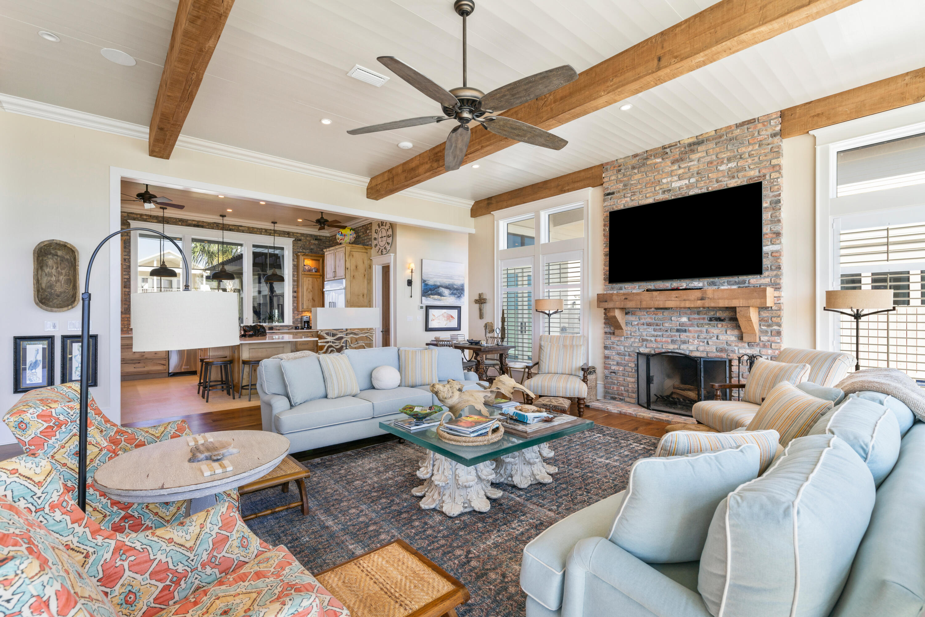 556 Blue Mountain Road Santa Rosa Beach, FL 32459 - Photo 22 of 72 a living room with furniture a fireplace and a flat screen tv