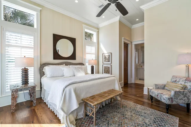 a bedroom with a bed window and a flat screen tv