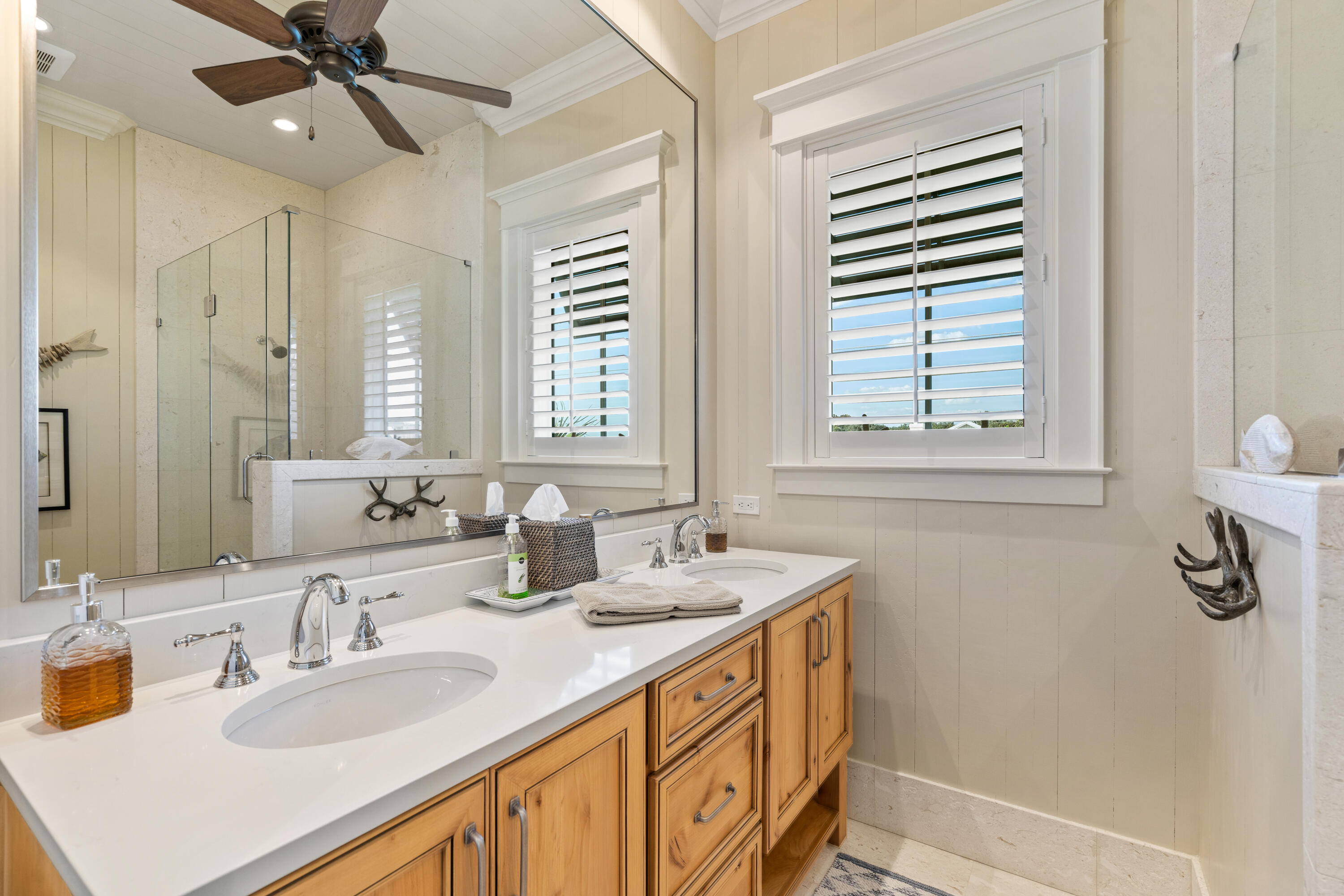 556 Blue Mountain Road Santa Rosa Beach, FL 32459 - Photo 41 of 72 a bathroom with double vanity sinks a mirror and a shower