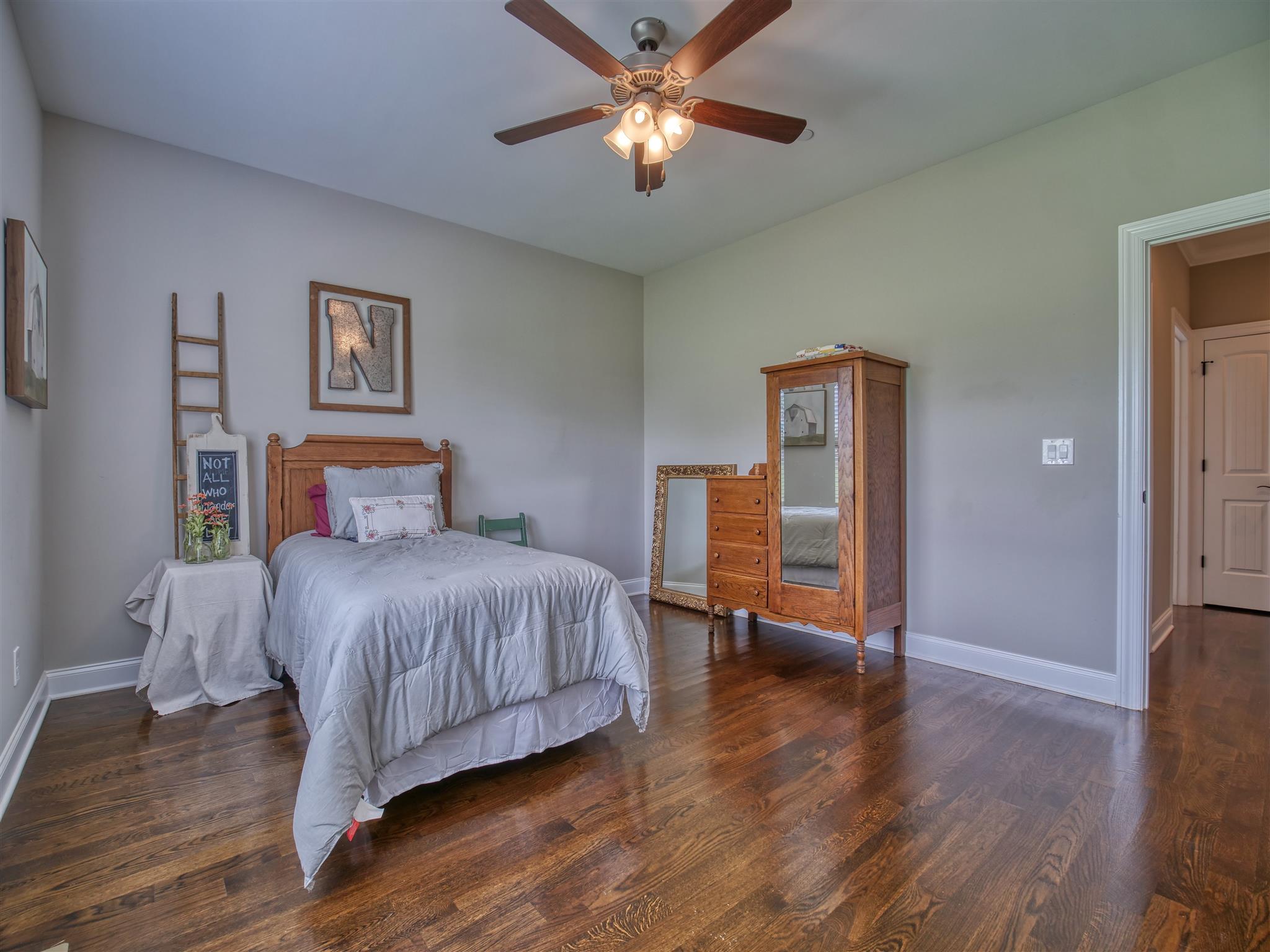 9590 Mona Road Murfreesboro, TN 37129 - Photo 23 of 30 a bedroom with a bed and wooden floor