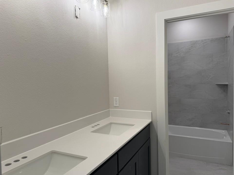 2209 Continent Court Krum, TX 76249 - Photo 18 of 24 a bathroom with a sink and a bathtub