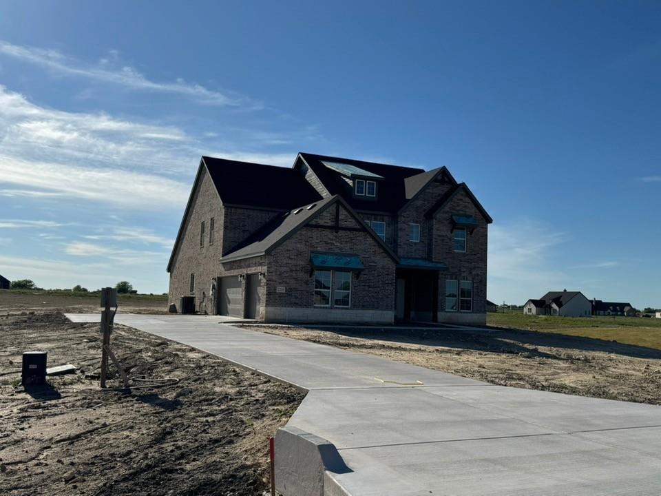 2209 Continent Court Krum, TX 76249 - Photo 4 of 24 a front view of a house with a yard