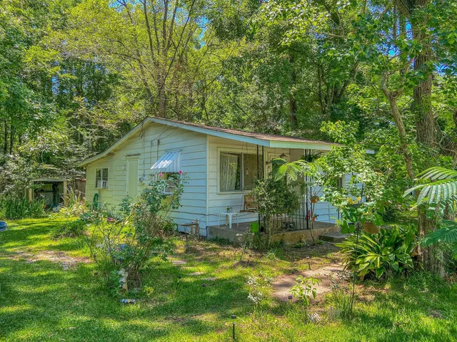 a backyard of a house with plants and garden