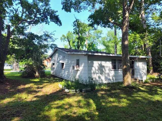 a backyard of a house with yard and outdoor seating
