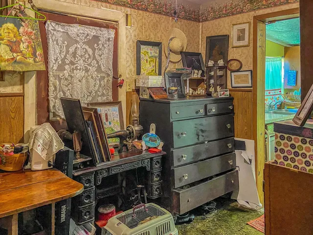 a view of a workspace with furniture and a floor to ceiling window