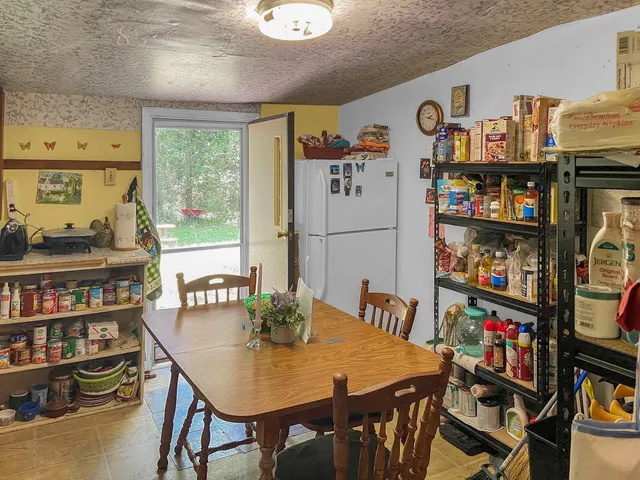 a view of a dining room with furniture and a book shelf