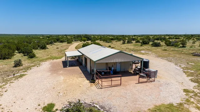 a view of a green field with lots of trees