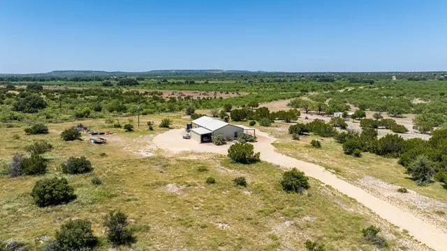 a view of a house with wooden bench and floor