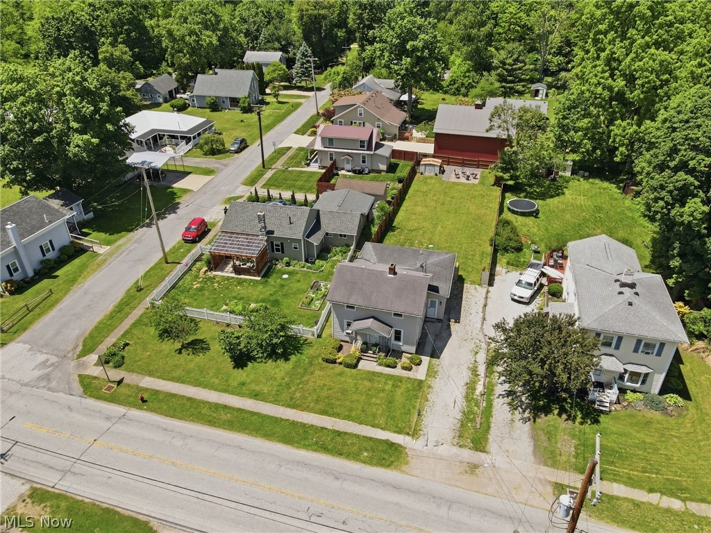 3490 County Line Road Madison, OH 44057 - Photo 41 of 42 Residential property featuring a light-colored exterior, an asphalt shingle roof, and a mature tree