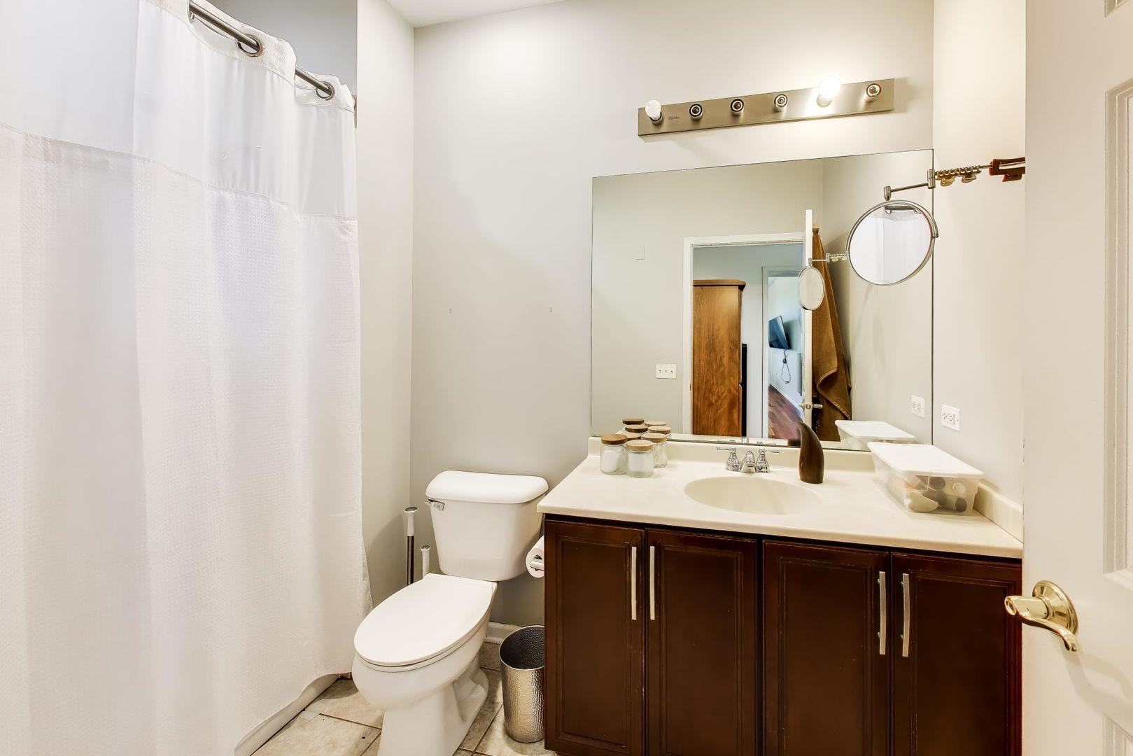 500 East St Charles Road, Unit 510 Lombard, IL 60148 - Photo 18 of 28 a bathroom with a toilet sink and mirror