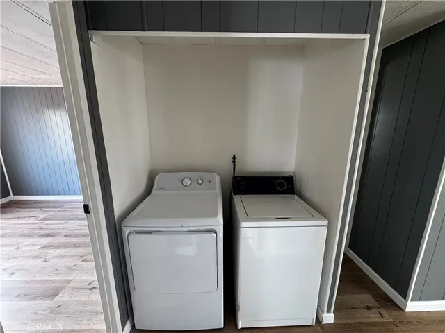 a view of empty room with window and wooden floor