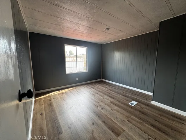 a view of room with window and wooden floor