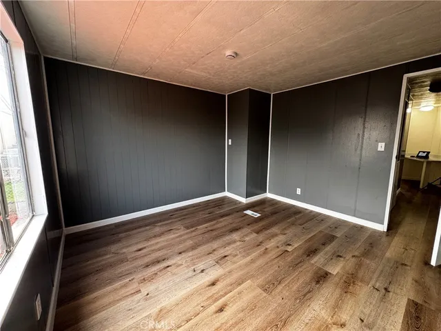 a view of room with wooden floor