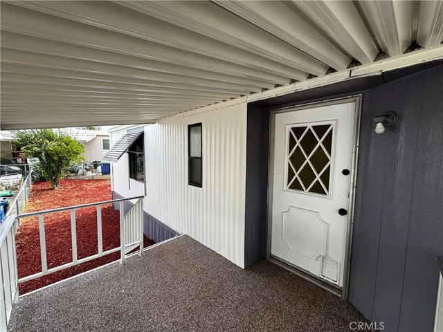 a view of a porch with furniture and front door