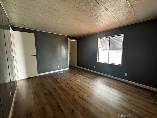 a bathroom with a granite countertop sink toilet and a mirror