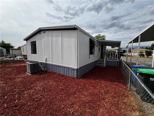 a view of house with backyard and furniture