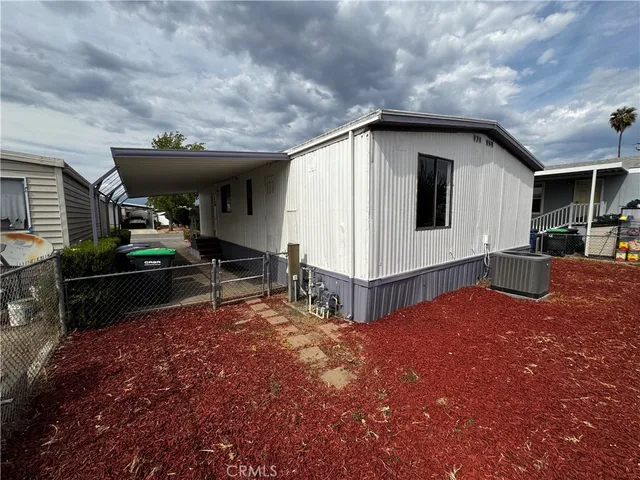 a view of a house with backyard and sitting area