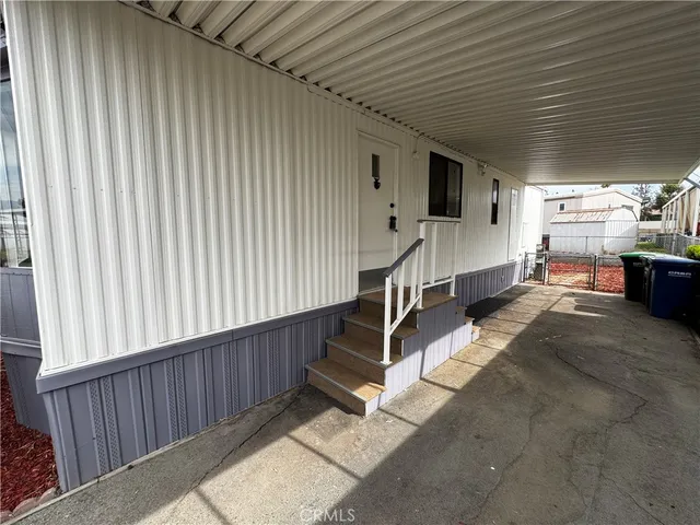 a living room with a furniture a flat screen tv and floor to ceiling window