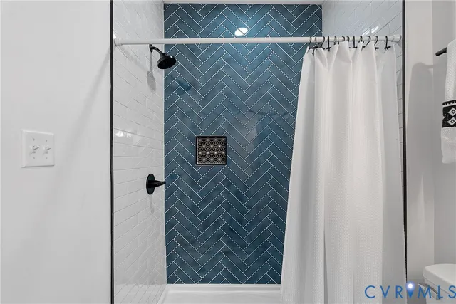 a bathroom with a shower and a sink