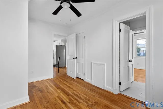 a view of empty room with wooden floor
