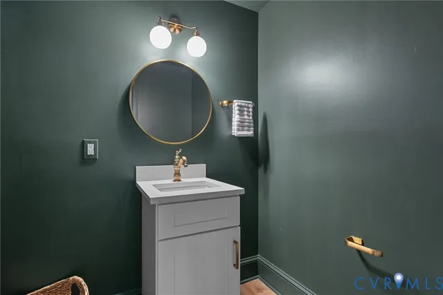 a bathroom with a sink mirror and vanity