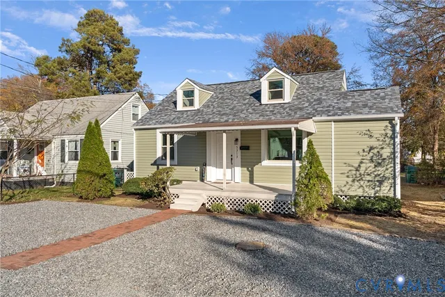 a front view of a house with a garden and pathway