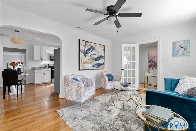a living room with furniture and wooden floor