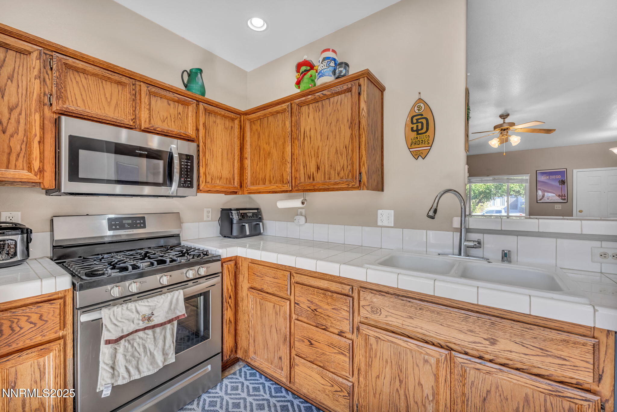 1295 Eider Circle Fallon, NV 89406 - Photo 11 of 37 a kitchen with granite countertop a sink cabinets stainless steel appliances and a counter top space
