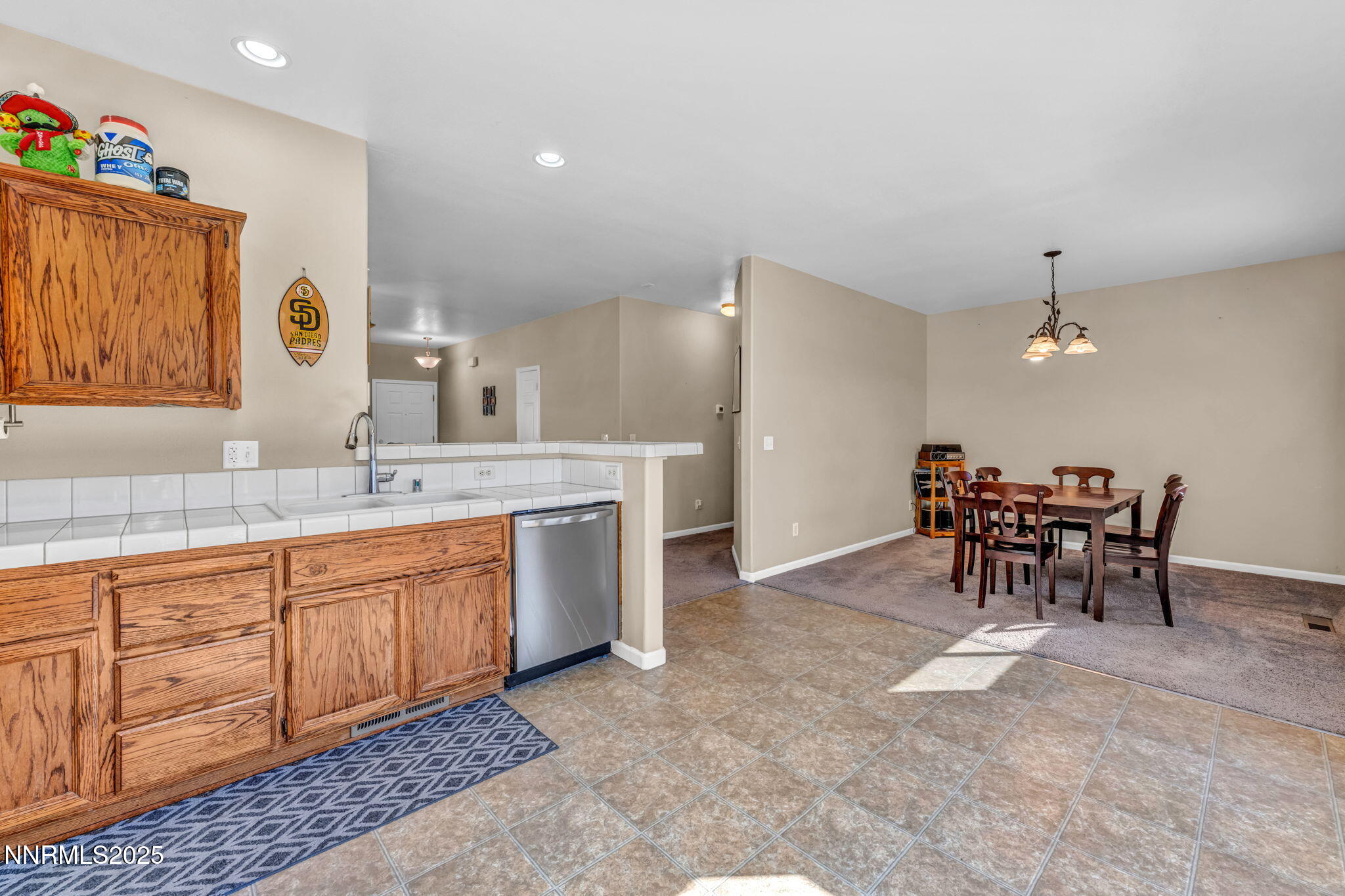 1295 Eider Circle Fallon, NV 89406 - Photo 13 of 37 a large kitchen with kitchen island a sink table and chairs