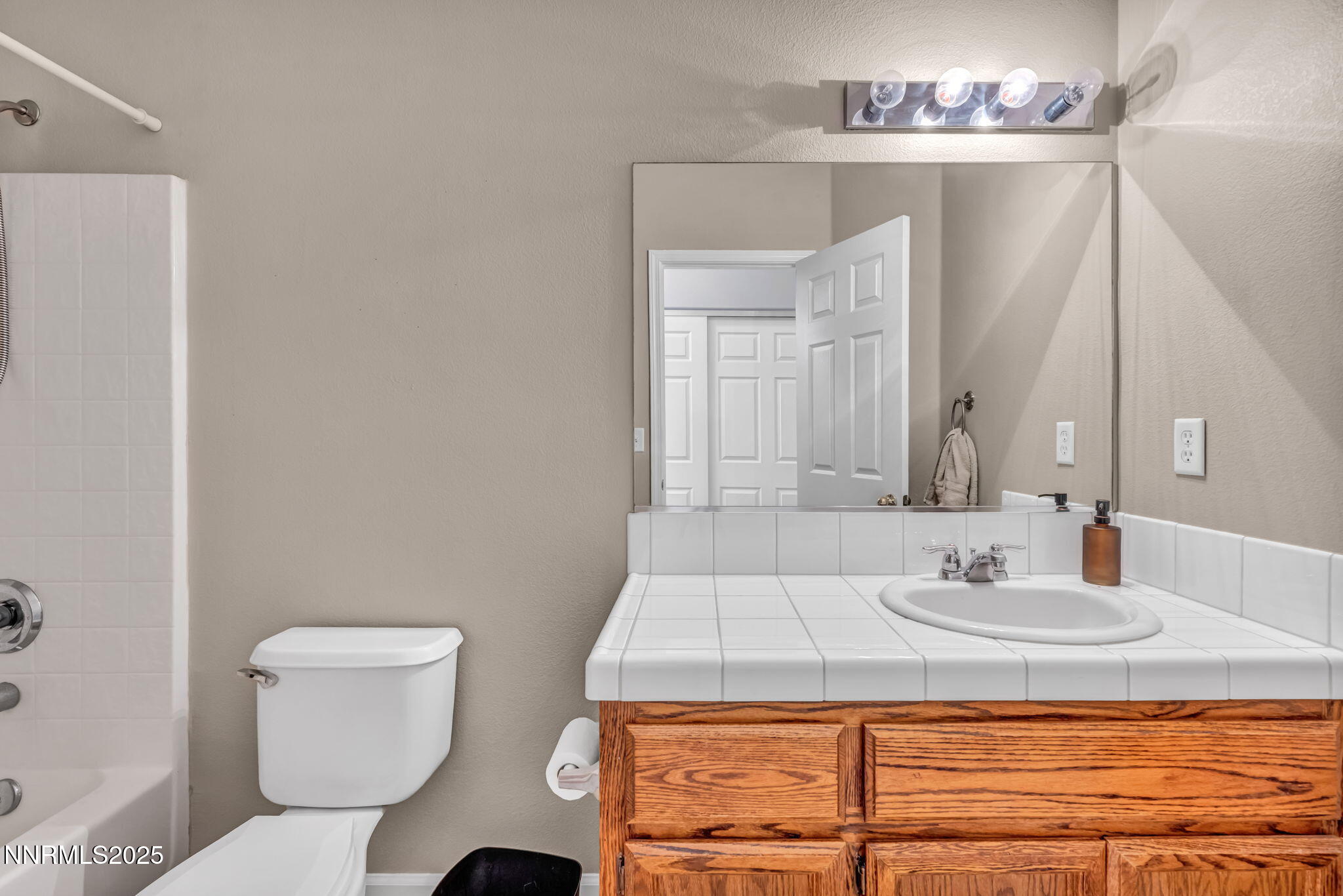 1295 Eider Circle Fallon, NV 89406 - Photo 19 of 37 a bathroom with a sink toilet and mirror