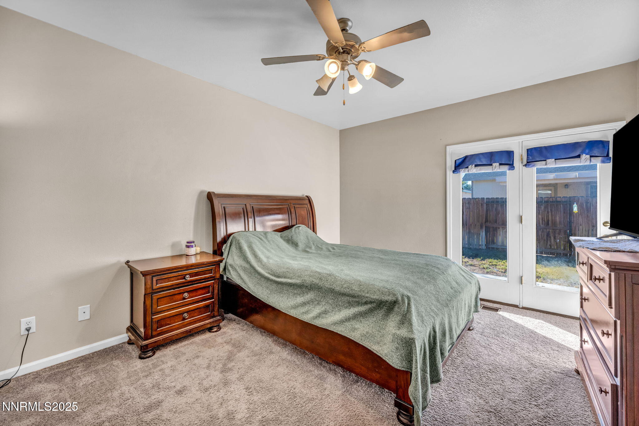 1295 Eider Circle Fallon, NV 89406 - Photo 21 of 37 a bedroom with a bed and a chandelier