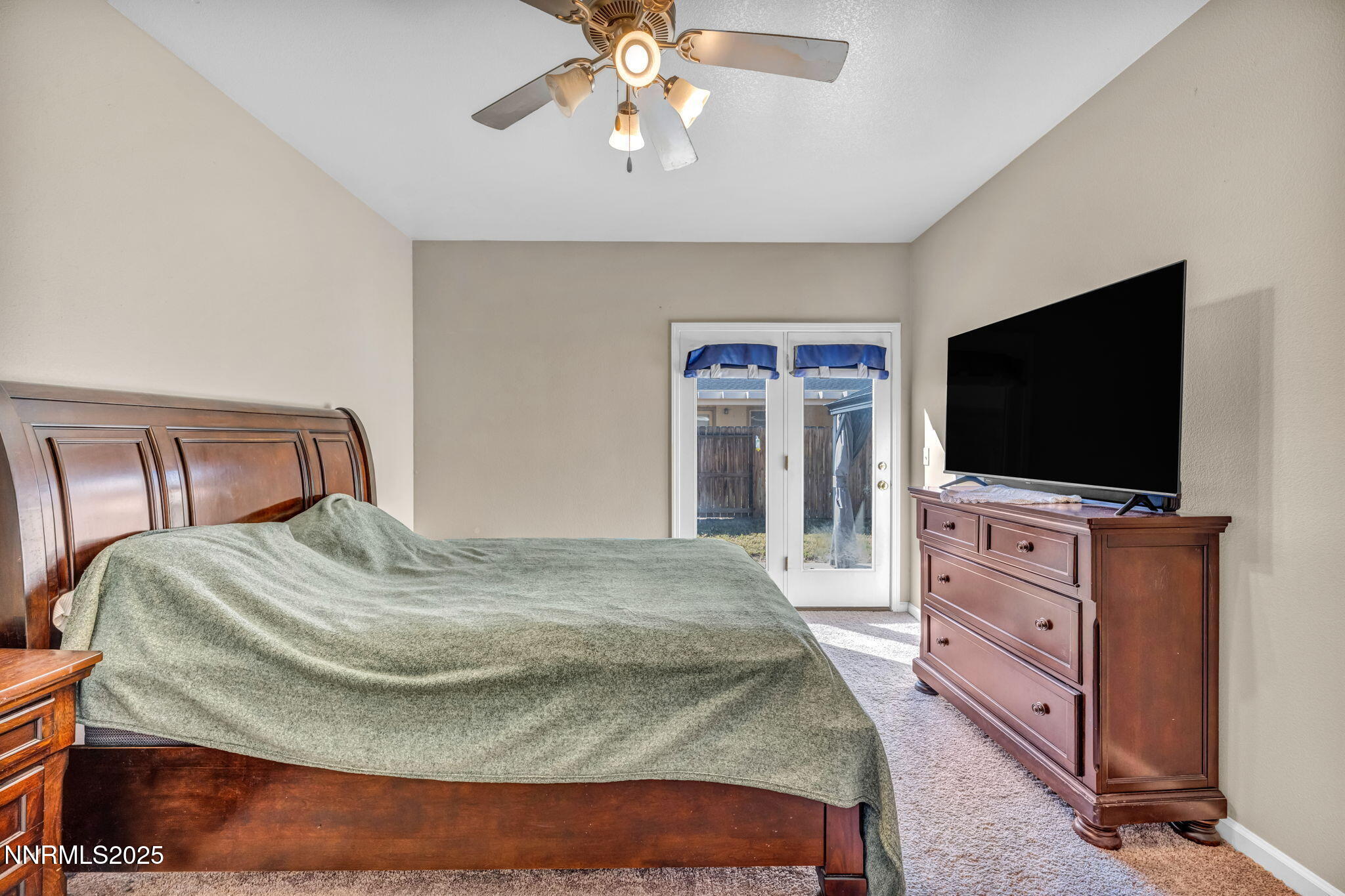 1295 Eider Circle Fallon, NV 89406 - Photo 22 of 37 a bedroom with a bed and a flat screen tv