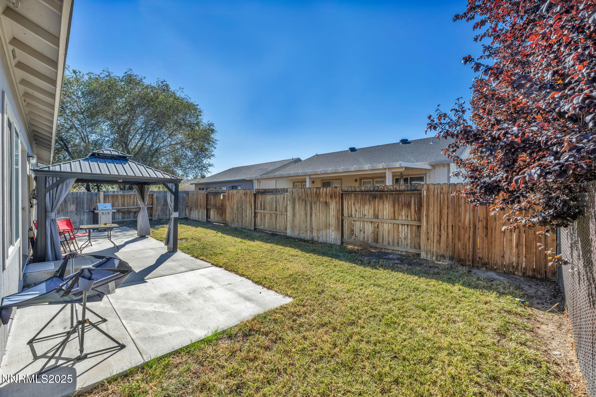 1295 Eider Circle Fallon, NV 89406 - Photo 35 of 37 a view of a backyard with table and chairs with wooden fence