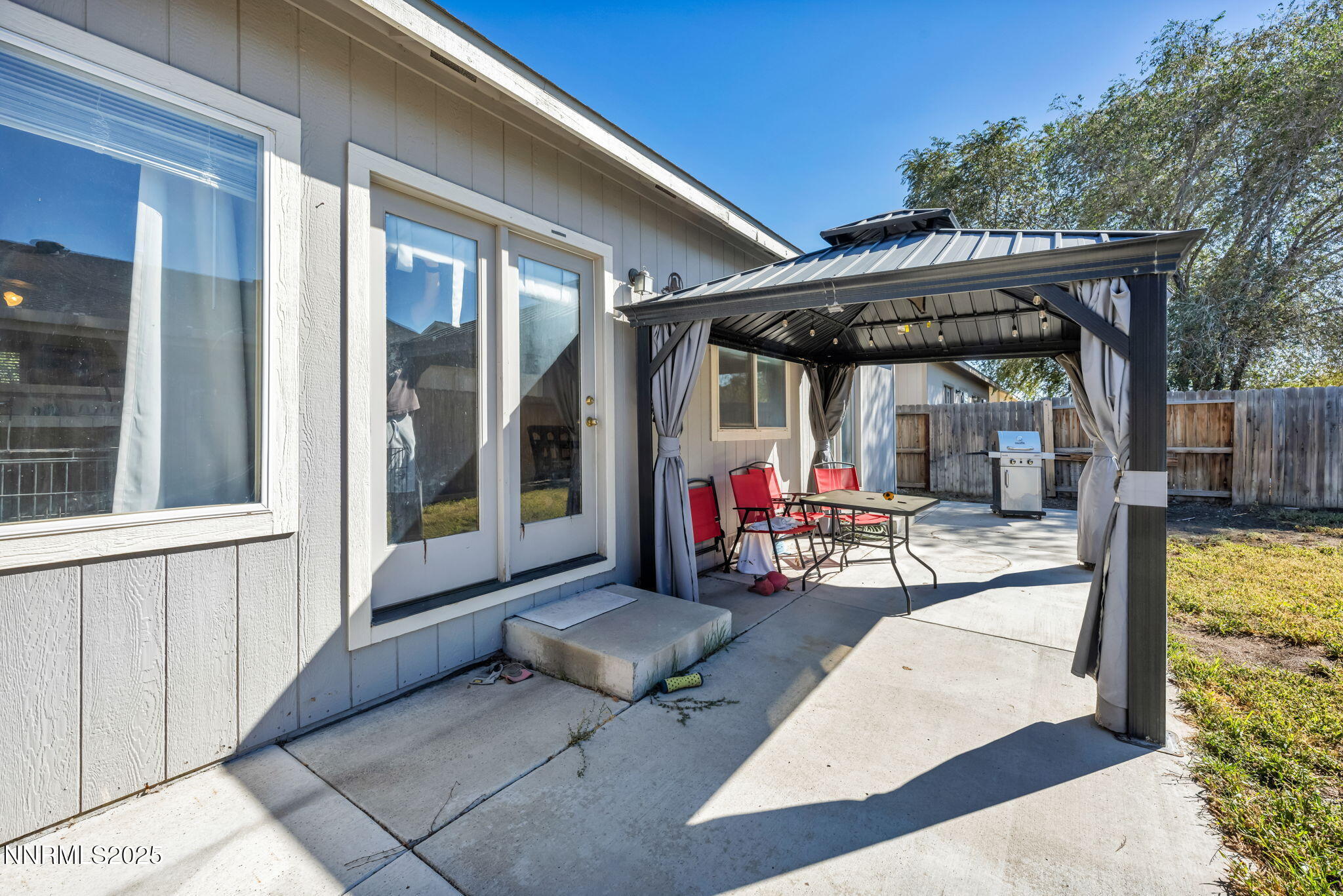 1295 Eider Circle Fallon, NV 89406 - Photo 36 of 37 a view of a patio with table and chairs under an umbrella