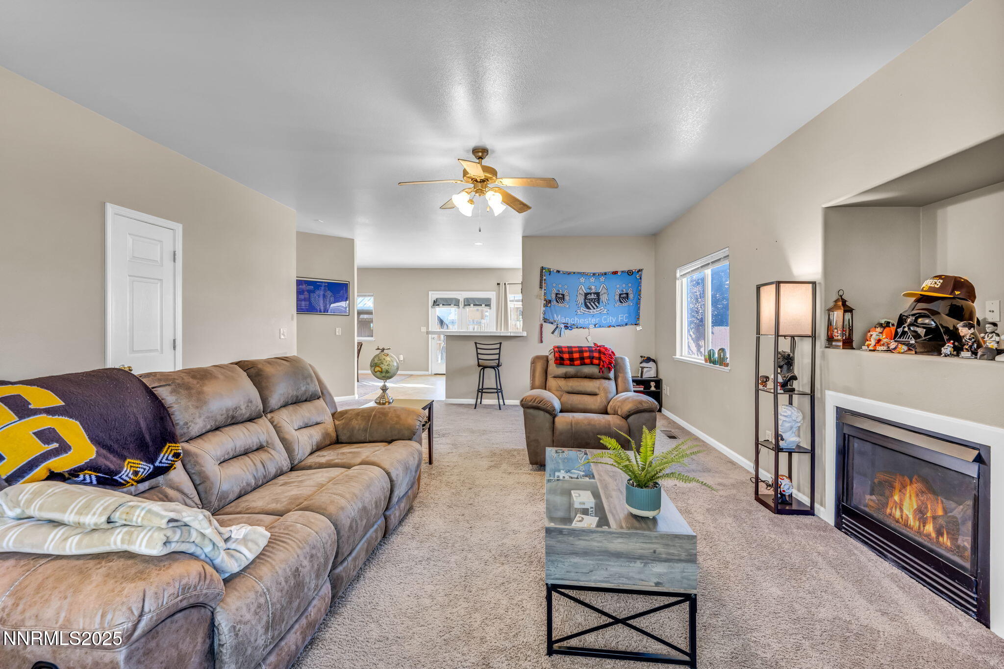 1295 Eider Circle Fallon, NV 89406 - Photo 6 of 37 a living room with furniture a fireplace and a flat screen tv