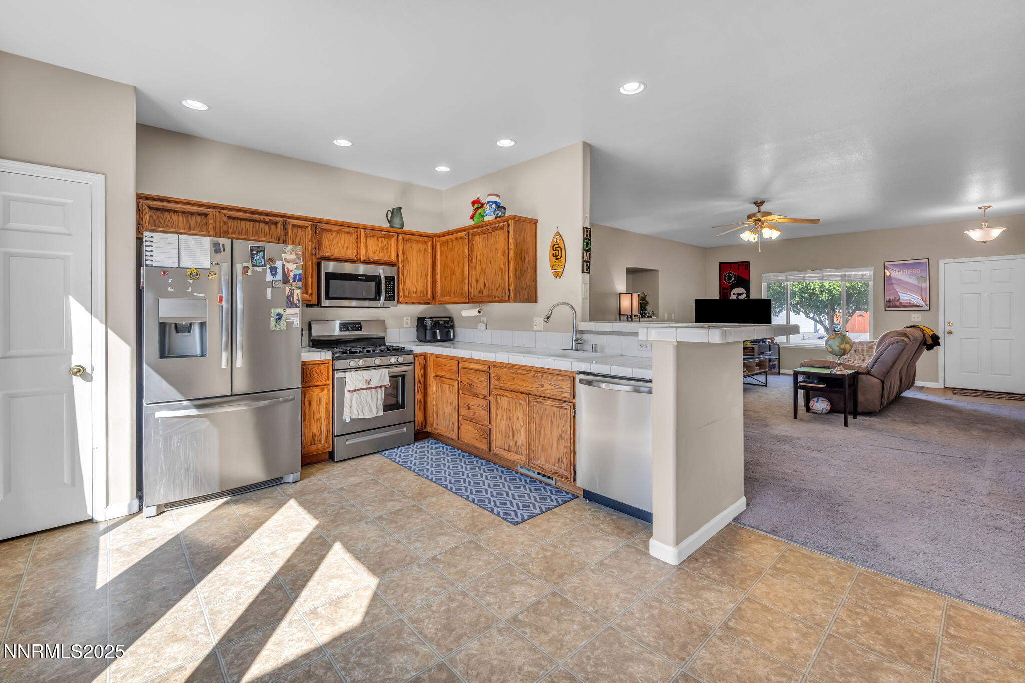 1295 Eider Circle Fallon, NV 89406 - Photo 9 of 37 a kitchen with a sink a counter top space stainless steel appliances cabinets and a counter top space