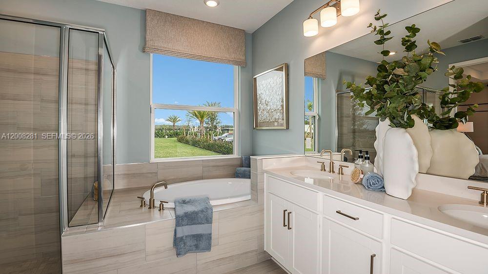 653 Southeast Ranch Oak Circle Port St. Lucie, FL 34984 - Photo 17 of 43 a bathroom with a granite countertop sink a mirror and a shower