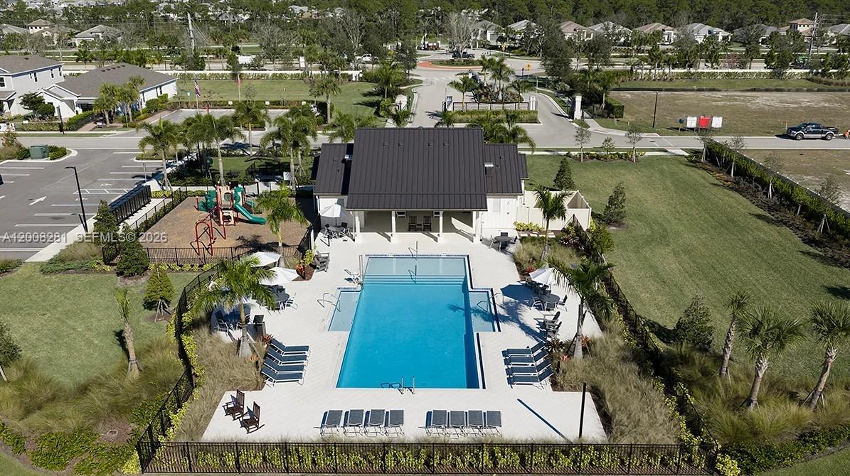 653 Southeast Ranch Oak Circle Port St. Lucie, FL 34984 - Photo 36 of 43 an aerial view of residential houses with outdoor space