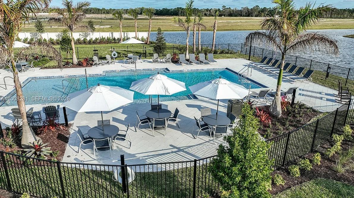 653 Southeast Ranch Oak Circle Port St. Lucie, FL 34984 - Photo 39 of 43 a view of a swimming pool and outdoor seating