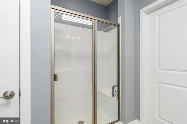 a bathroom with a glass shower door
