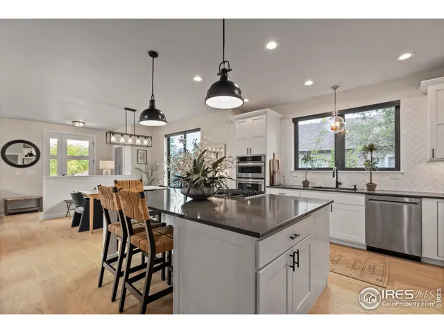 a kitchen with stainless steel appliances kitchen island granite countertop a sink and cabinets